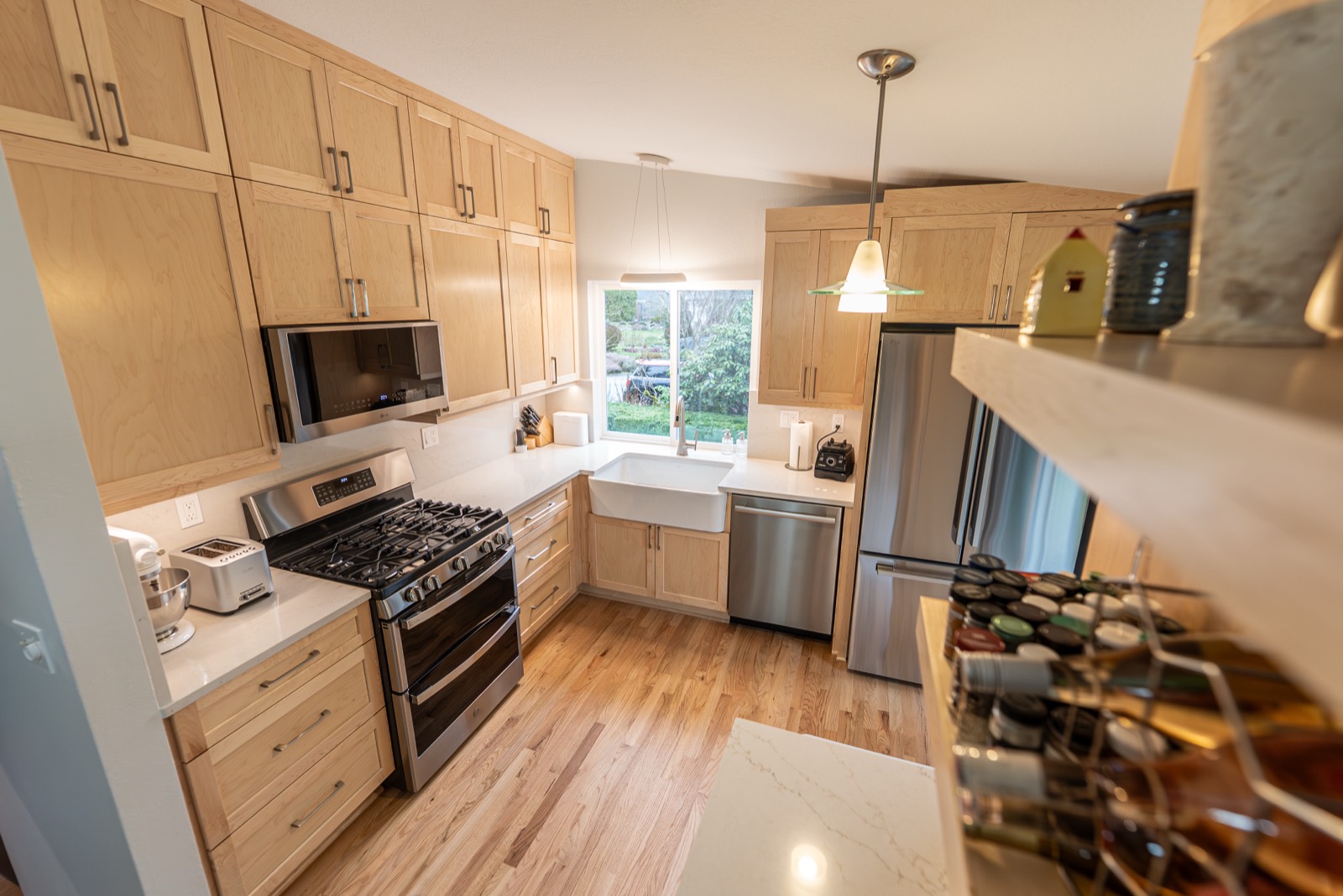 Kitchen remodel with white and wood cabinets and a farmhouse sink