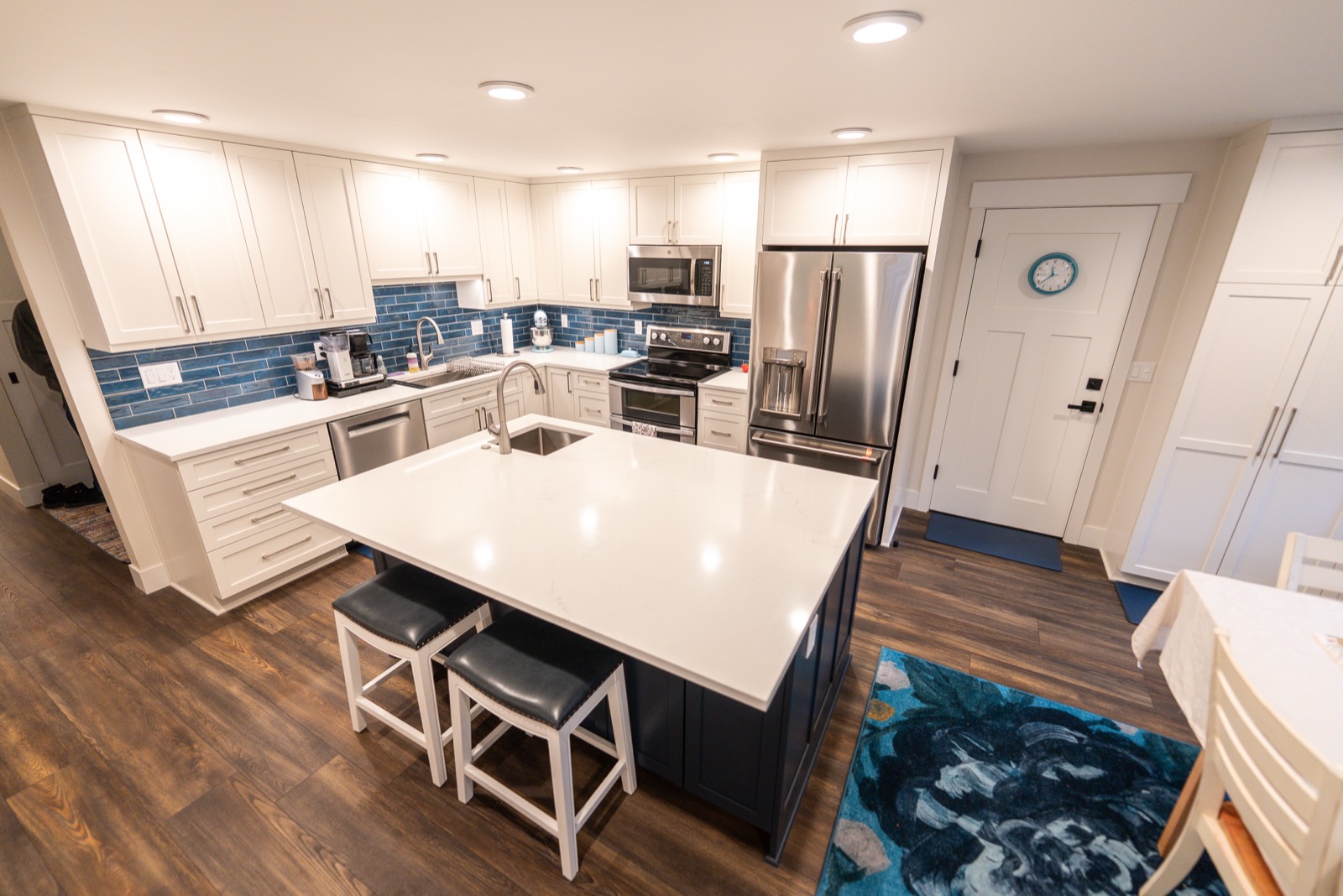Kitchen remodel with a navy island and white countertops