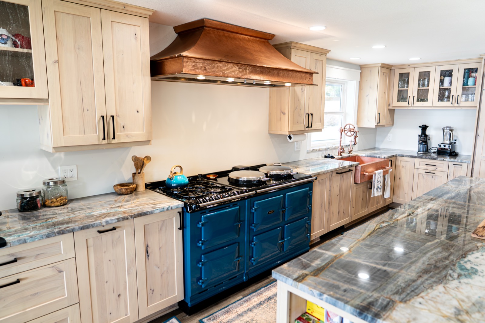Kitchen remodel with a blue range and copper hood